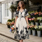 Vestido midi elegante con escote en V y estampado botánic